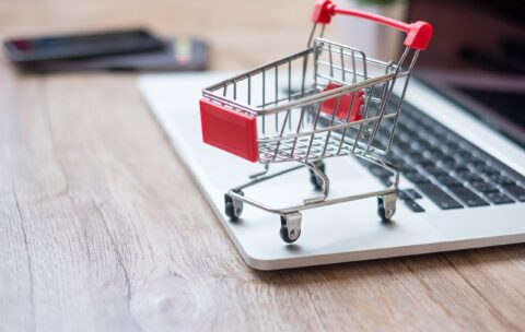 Shopping cart on laptop at home office. business, e-business, te